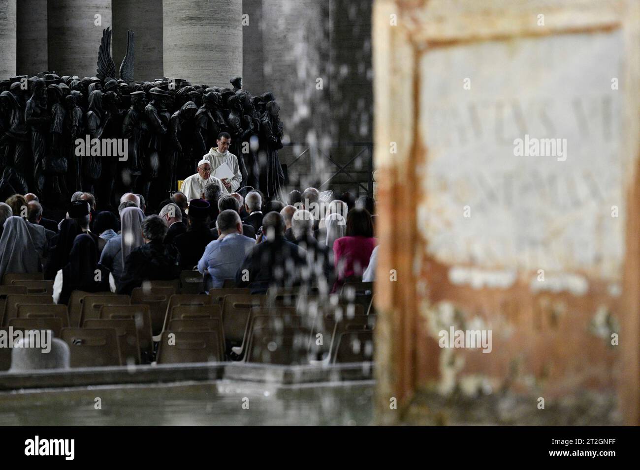 Vatican, Vatican. 19th Oct, 2023. Italy, Rome, Vatican, 2023/10/19 Pope Francis leads a prayer for migrants and refugees, part of the 16th general assembly of the synod of bishops, in front of Timothy Schmalz's bronze sculptural complex 'Angels Unawares' and the San Damiano Cross, left, a large Romanesque rood before which St. Francis of Assisi was praying when he is said to have received the commission from the Lord to rebuild the Church, in St. Peter's Square at The Vatican Photograph by VATICAN MEDIA/Catholic Press Photo Credit: Independent Photo Agency/Alamy Live News Stock Photo