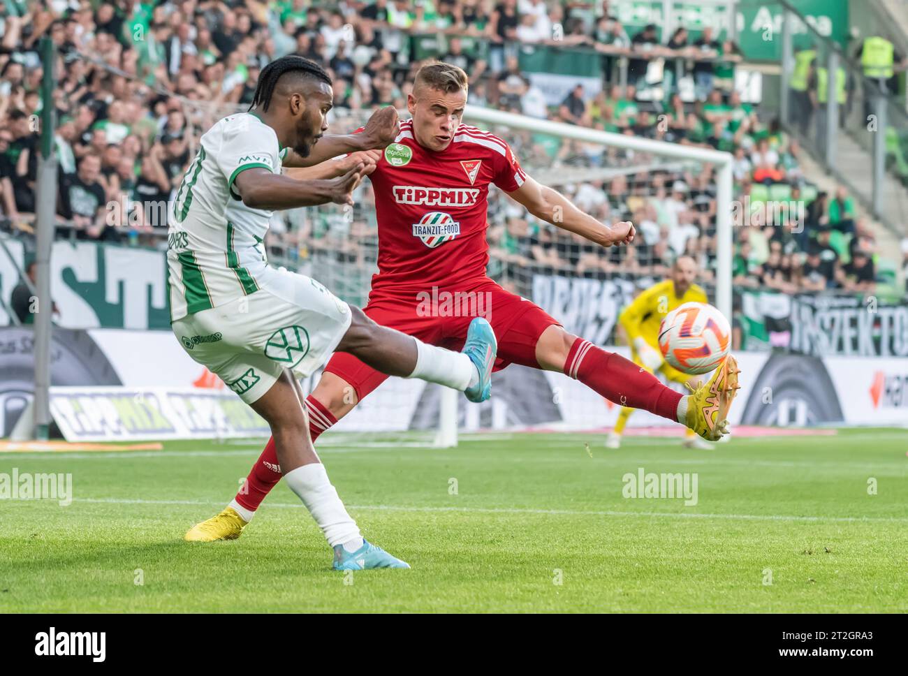 Budapest, Hungary – May 20, 2023. Debrecen midfielder Erik Kusnyir trying to block a dangerous cross from Ferencvaros striker Marquinhos during Hungar Stock Photo