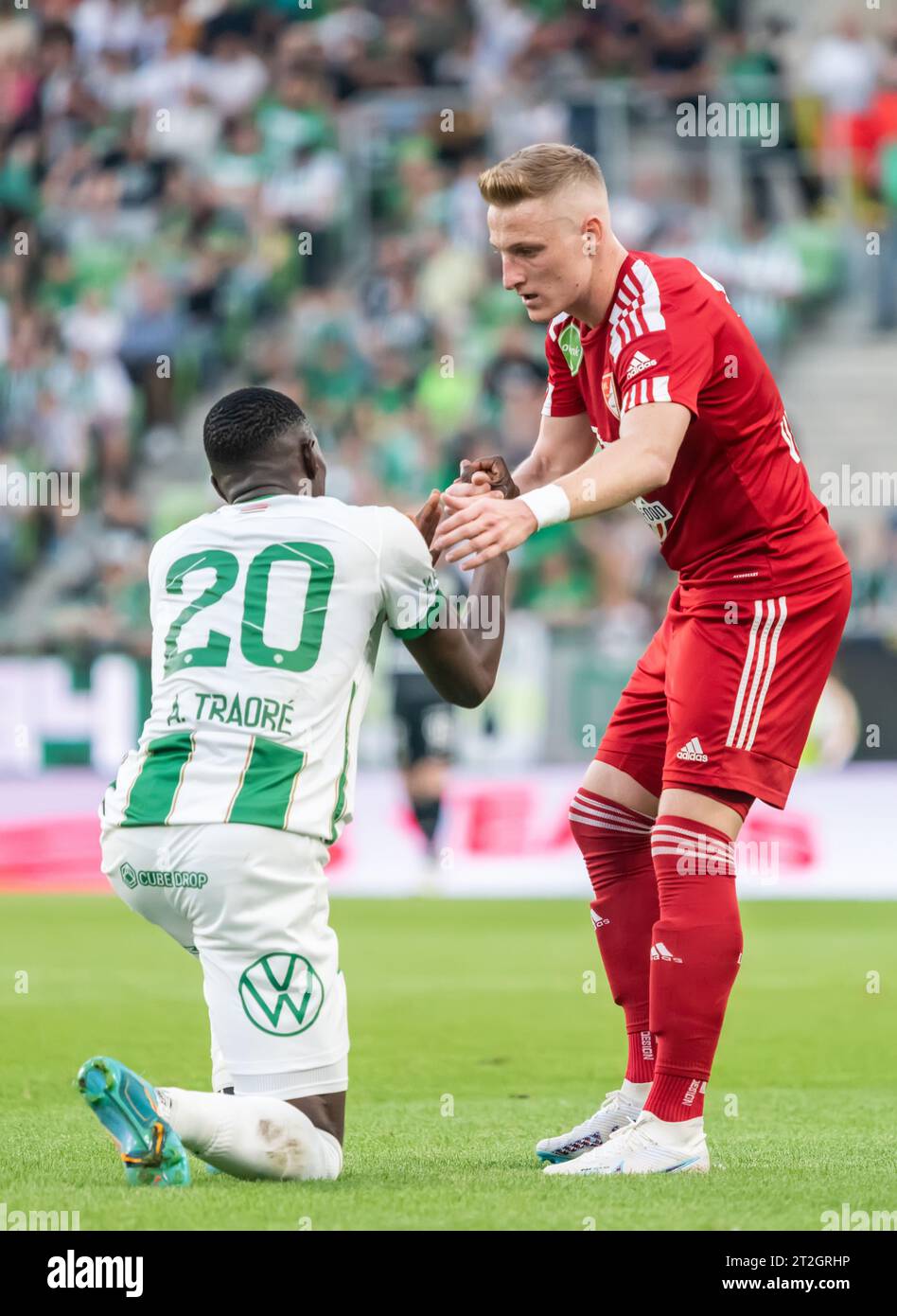Budapest, Hungary – May 20, 2023. Debrecen midfielder Kevin Varga helping Ferencvaros striker Adama Traore get off the ground during Hungarian OTP Ban Stock Photo