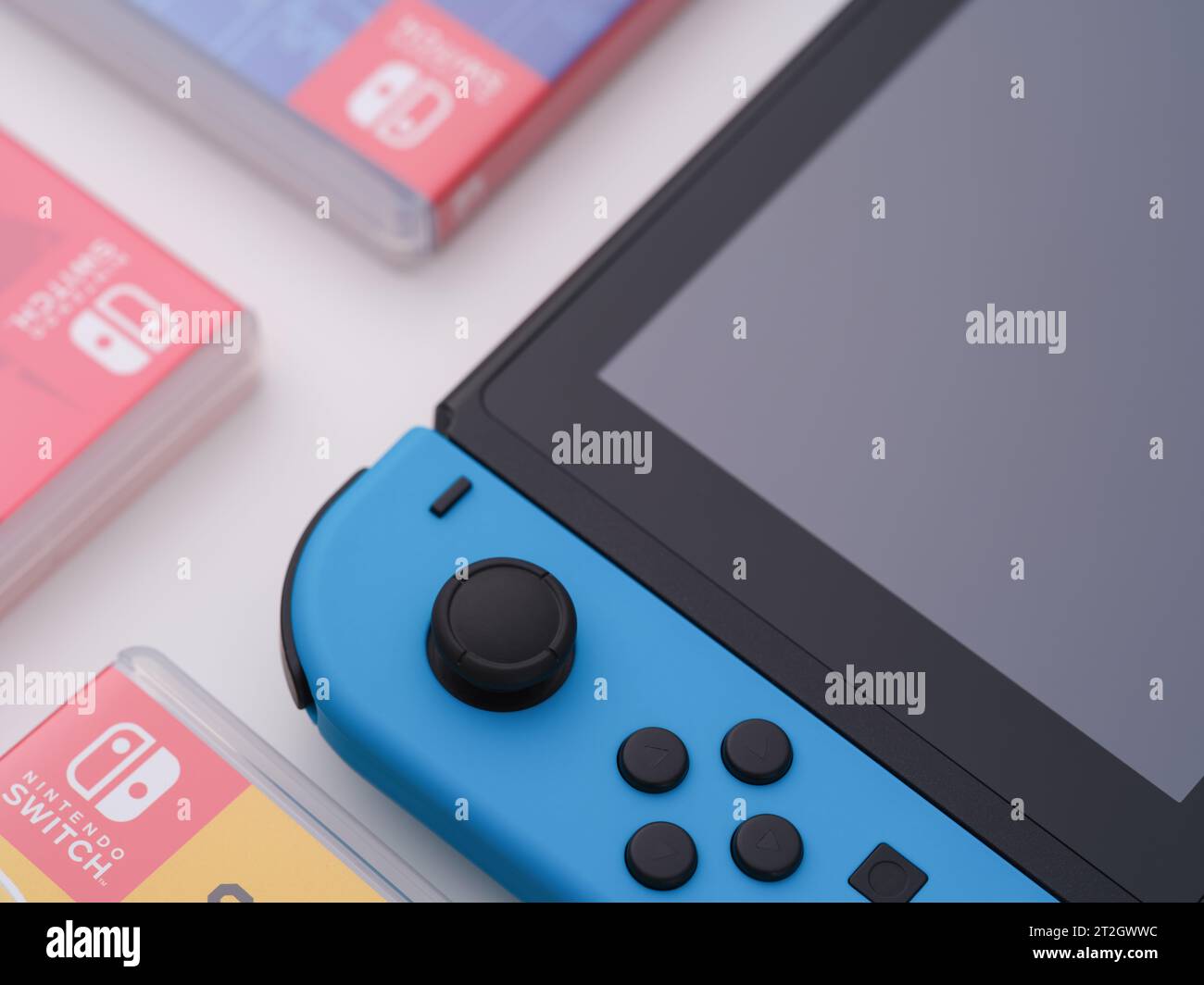Tambov, Russian Federation - October 15, 2023 A Nintendo Switch video game console with a blue joy-con and boxes with games next to it. Close up. Stock Photo
