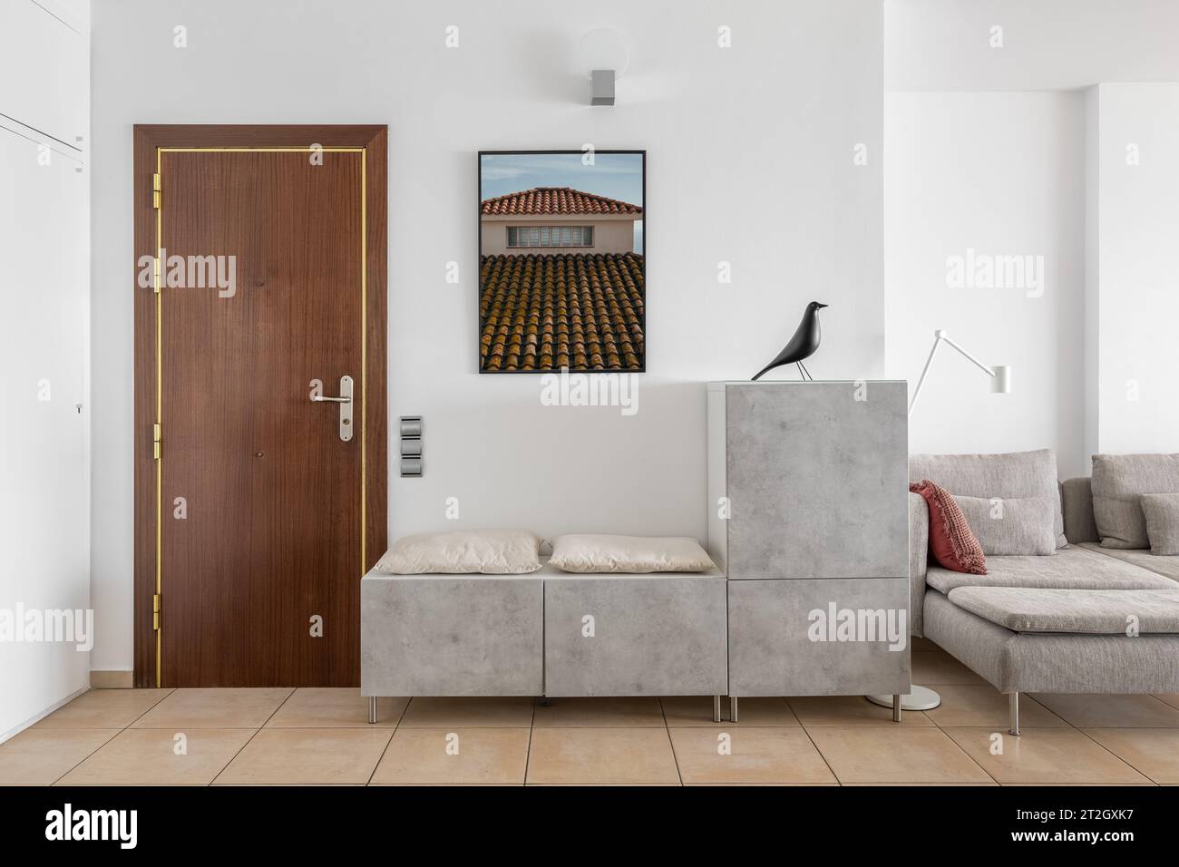Shoes rack with seats and picture in apartment entryway Stock Photo - Alamy