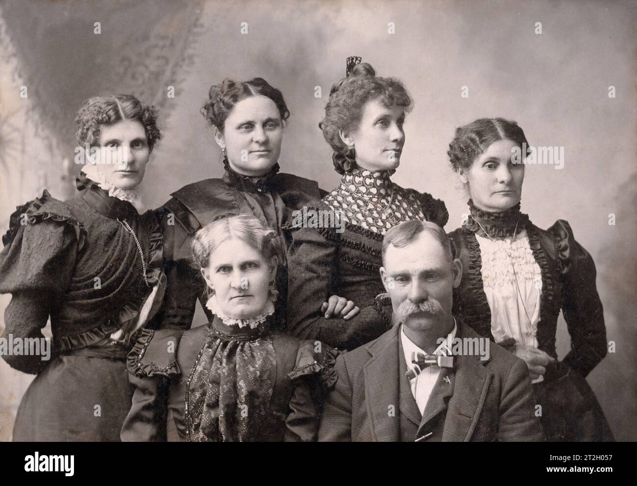 Family group photo in an American photography studio. The Father is wearing a Masonic square pin. Stock Photo