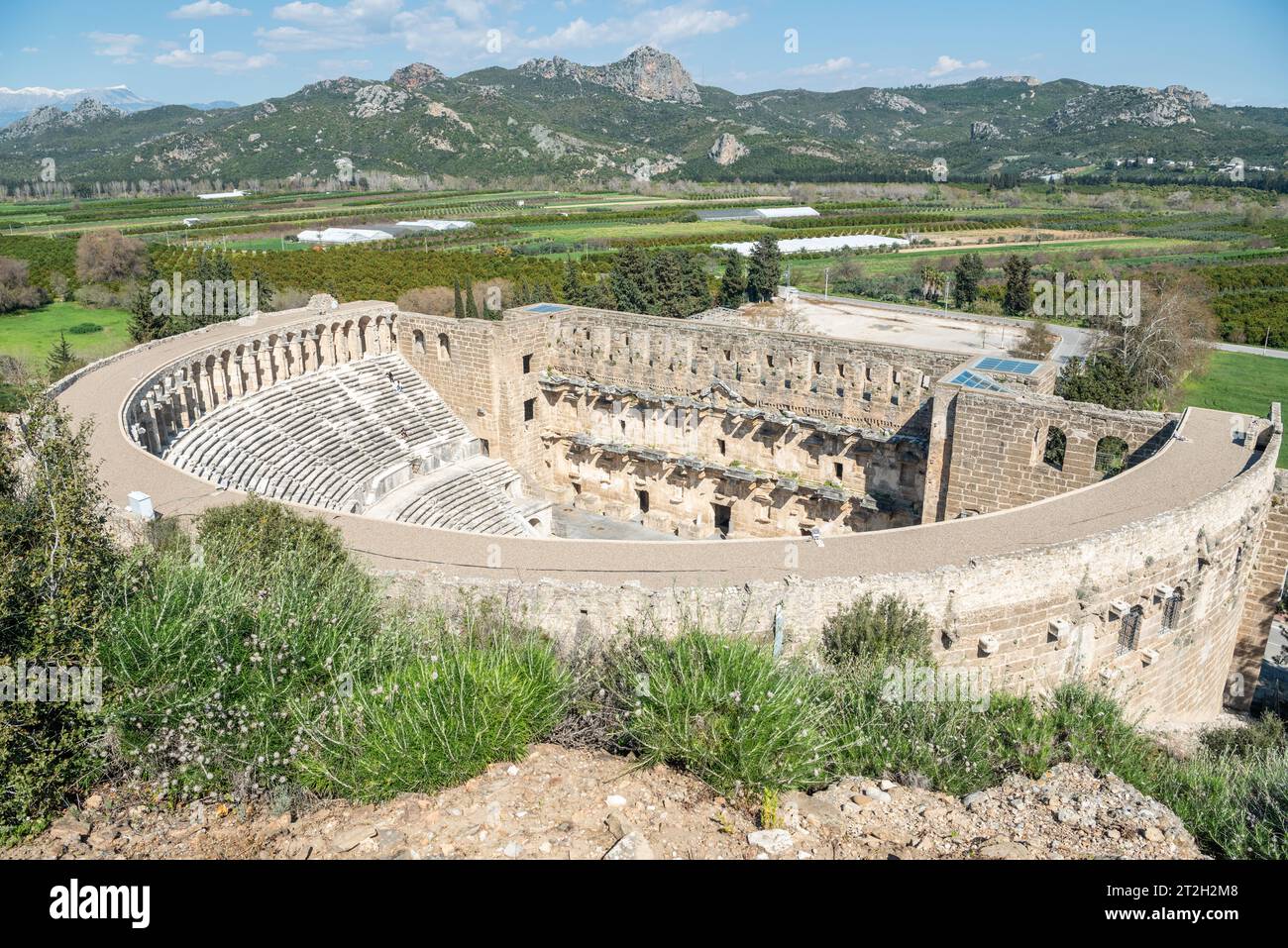 Exterior view of the Roman antique theatre building at Aspendos ancient site in Turkey. With a diameter of 96 metres, it provided seating for 7,000. I Stock Photo