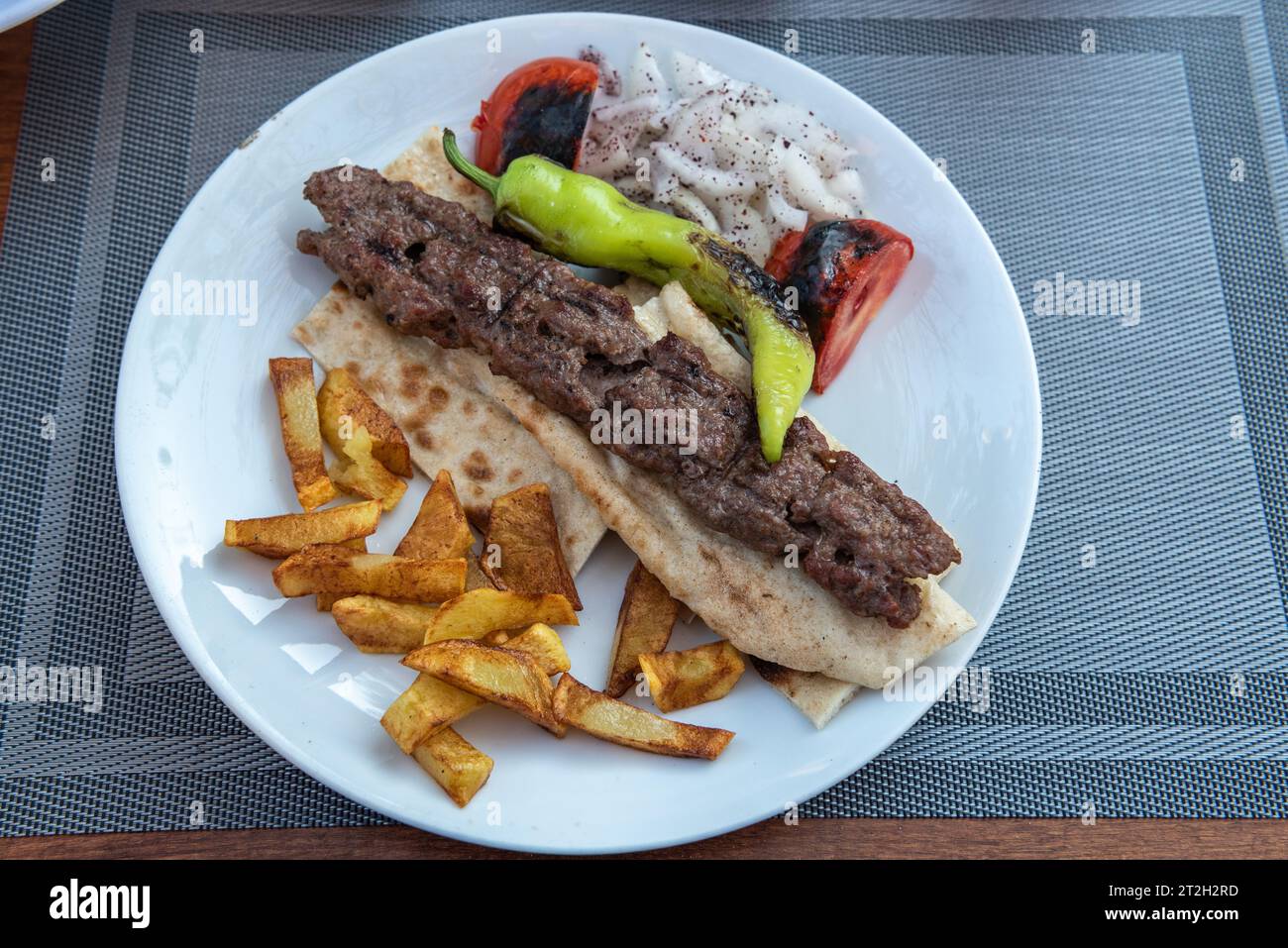 Turkish Urfa kebab. Kebab with lavas bread, potatoes and salad. Picture