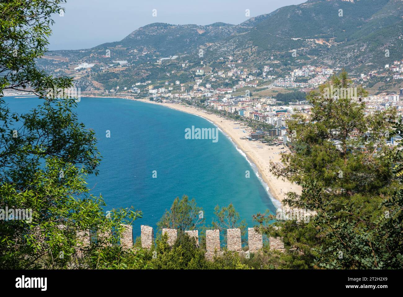 Aerial view over Cleopatra’s Beach in Alanya, Turkey. View across vegetation and castle walls. Stock Photo