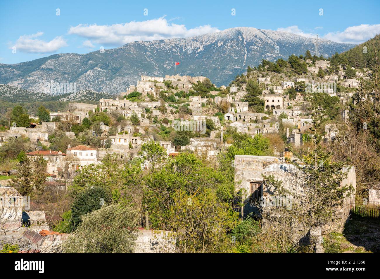 Ruined houses of Kayakoy (Levissi) abandoned village near Fethiye in Mugla province of Turkey. Levissi was deserted by its mostly Greek inhabitants in Stock Photo