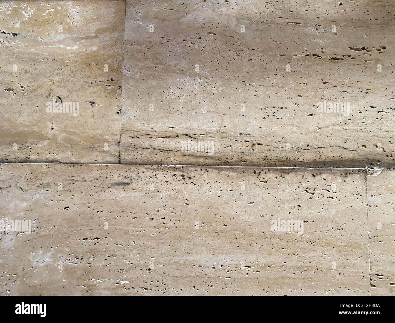 Textured wall lined with shell rock tiles. Stock Photo