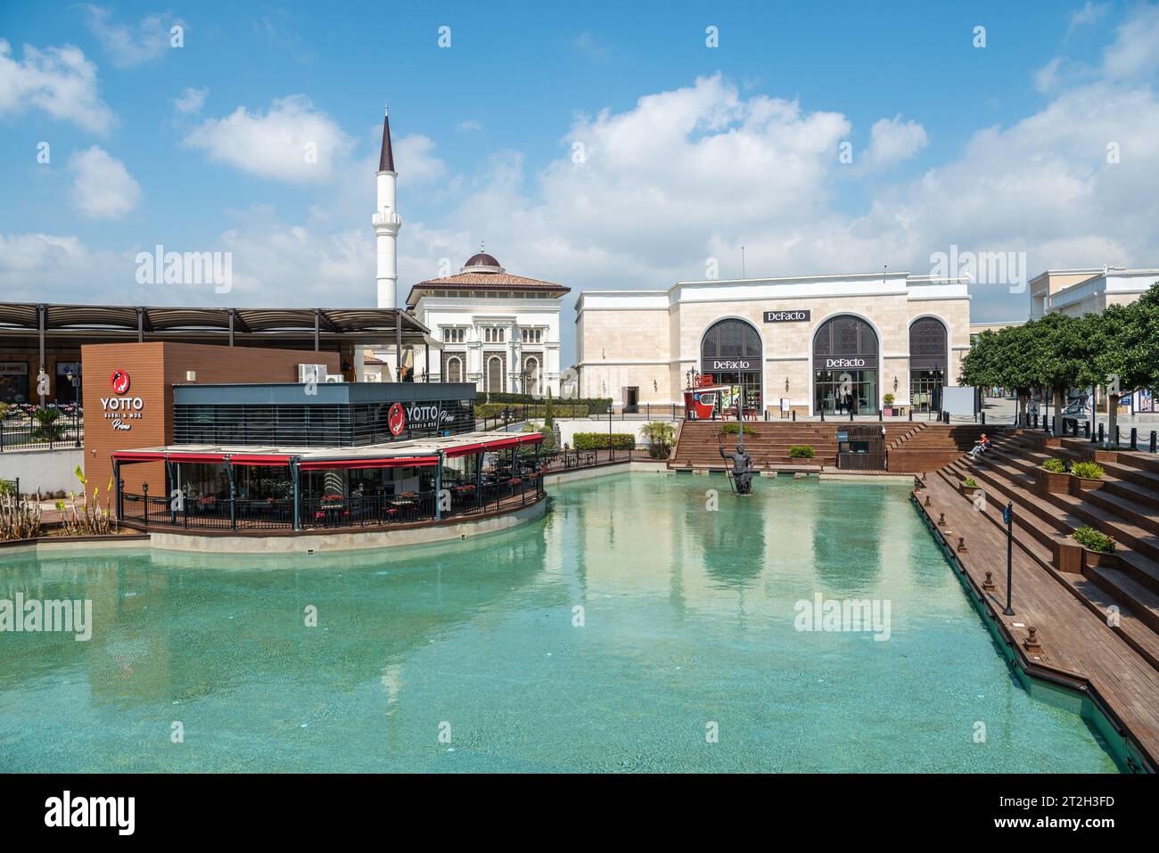 Belek, Antalya, Turkey - March 27, 2023. Land of Legends theme park in Belek, Turkey. View of a pool, mosque and shops. Stock Photo