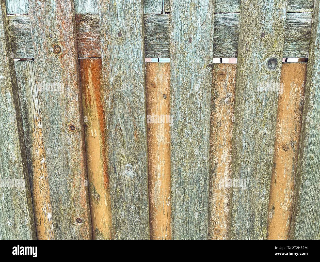 wooden fence made of sticks wrapped in thread. texture with wooden