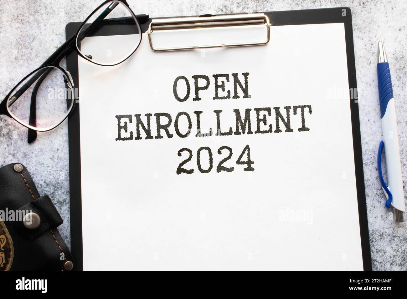 open enrollment 2024. text on a sticker next to money and banknotes, Stock Photo