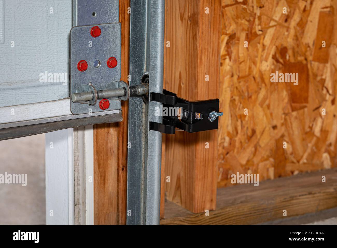 Overhead garage door opener safety sensor installed on roller track