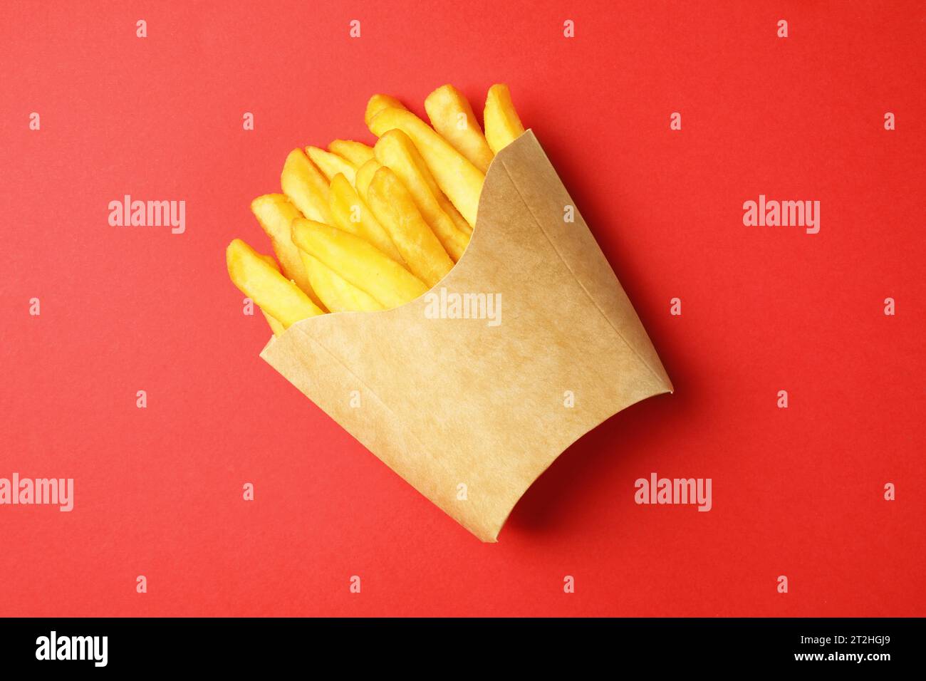 Paper cup with French fries on red table, top view Stock Photo - Alamy