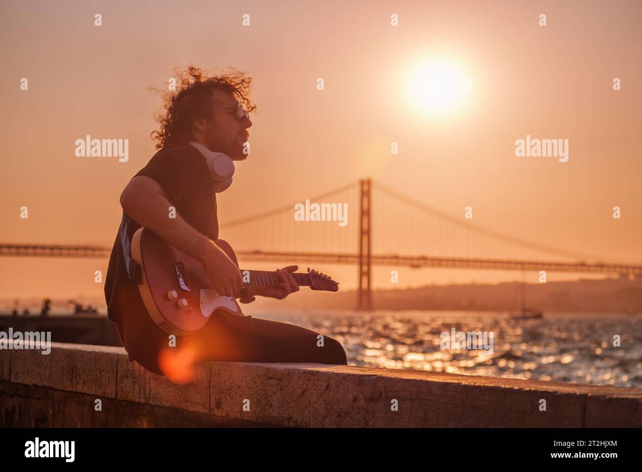 Street musician playing electric guitar in the street Stock Photo - Alamy