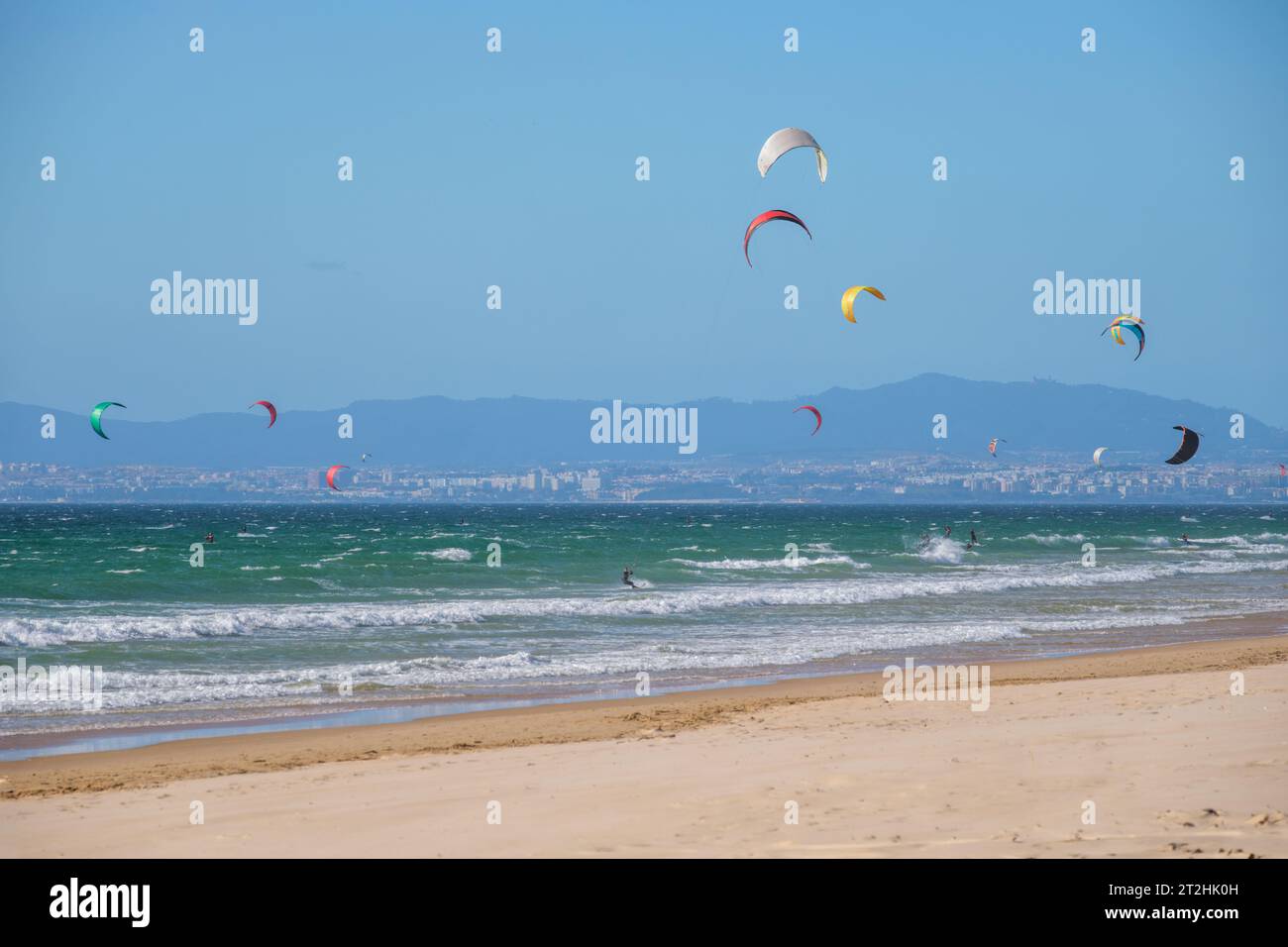 Kiteboarding kitesurfing kiteboarder kitesurfer kites on the ocean beach Stock Photo