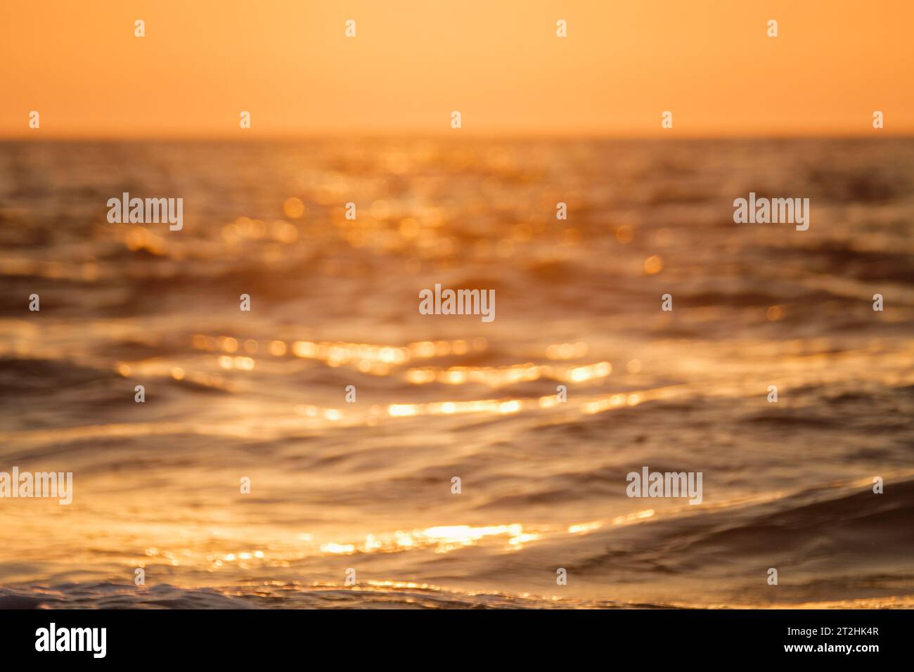 Ocean on sunset background Stock Photo - Alamy