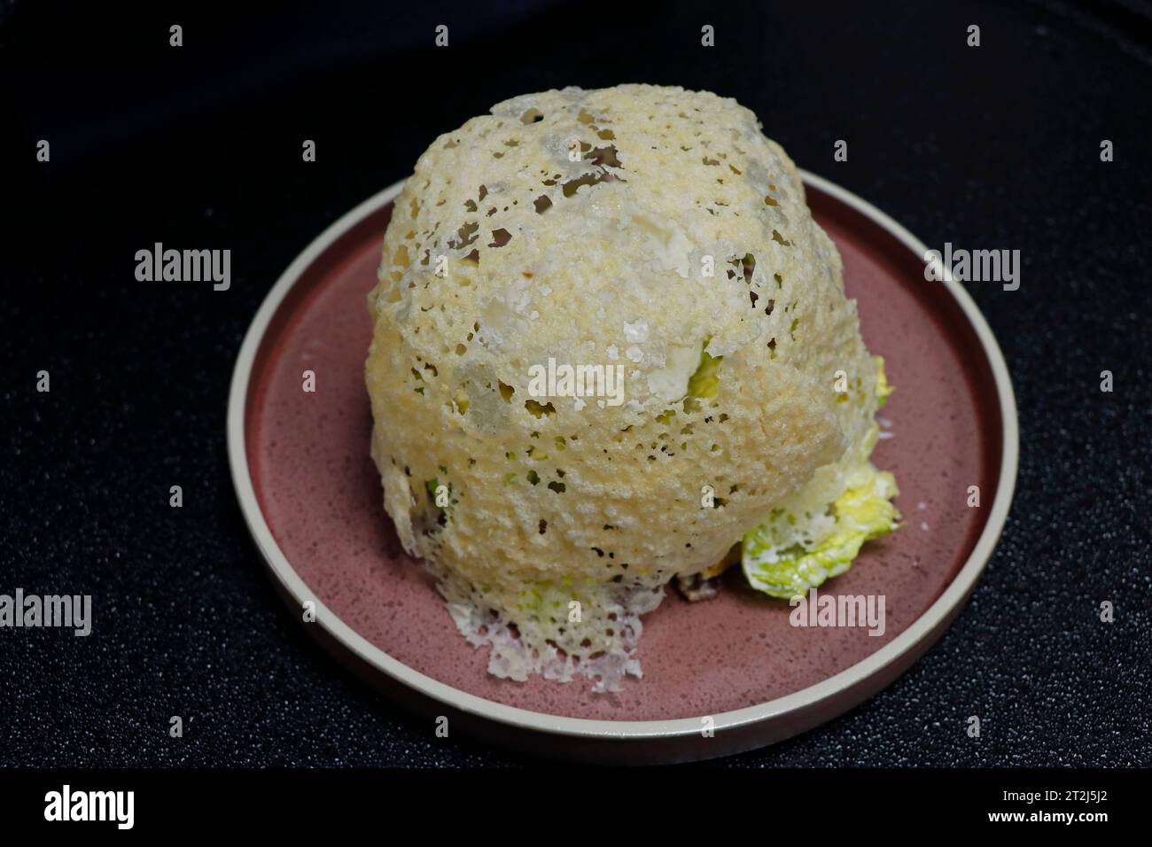 traditional chicken caesar salad with poached egg and parmesan cheese