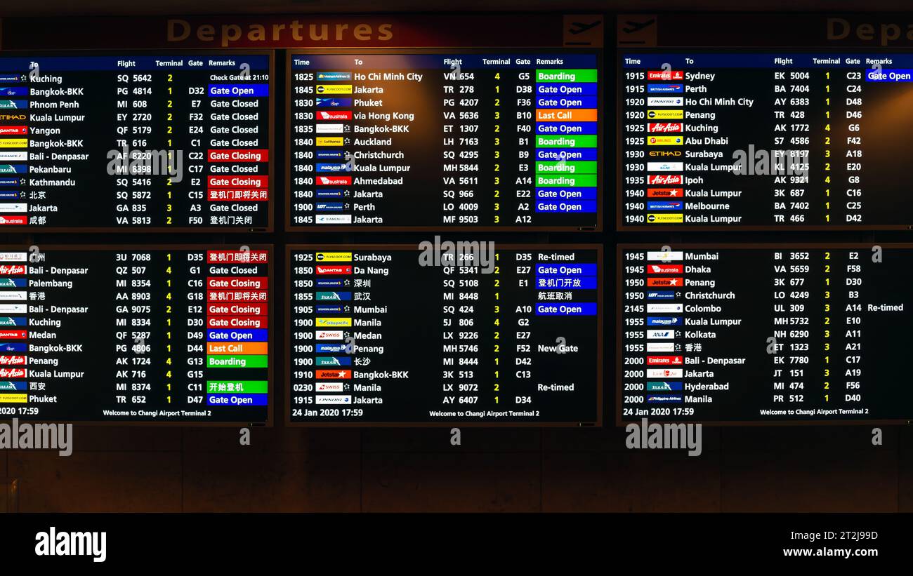 Changi Airport, Singapore - January 24, 2020: Real photo of departures board in Singapore airport  viewed from the inside main corridor Stock Photo