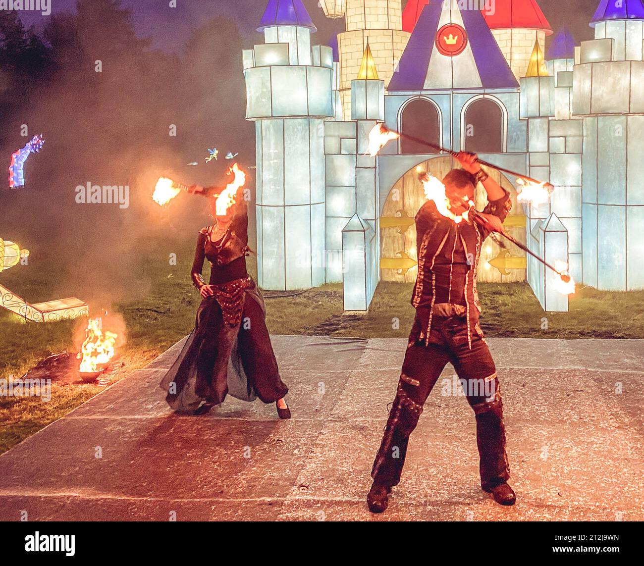 fire show, dancing with flame, male master fakir blowing fire, performance outdoors, flame control man dances with fire, with fire trails on a backgro Stock Photo
