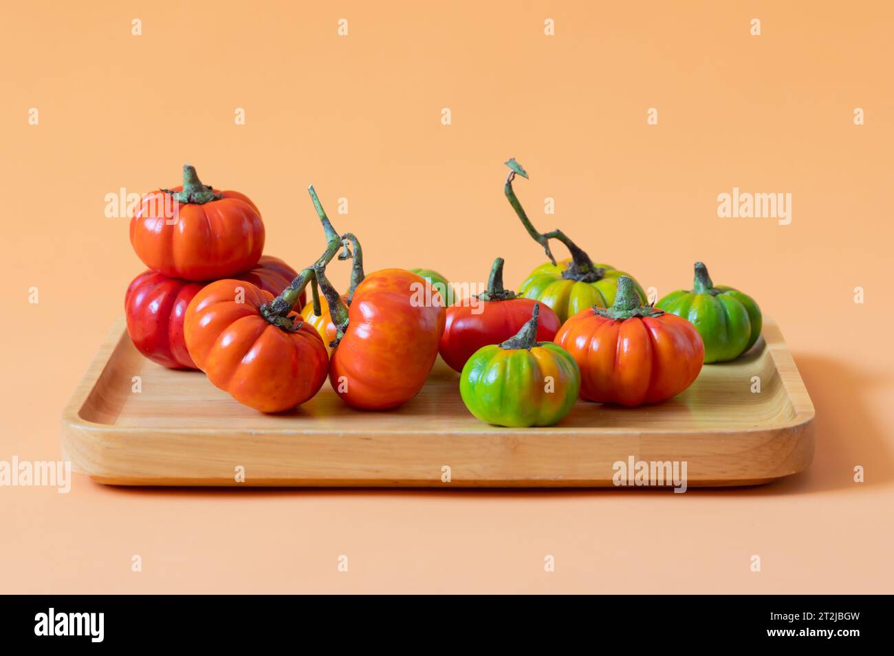 Fresh baby pumpkins on a wooden platter Stock Photo