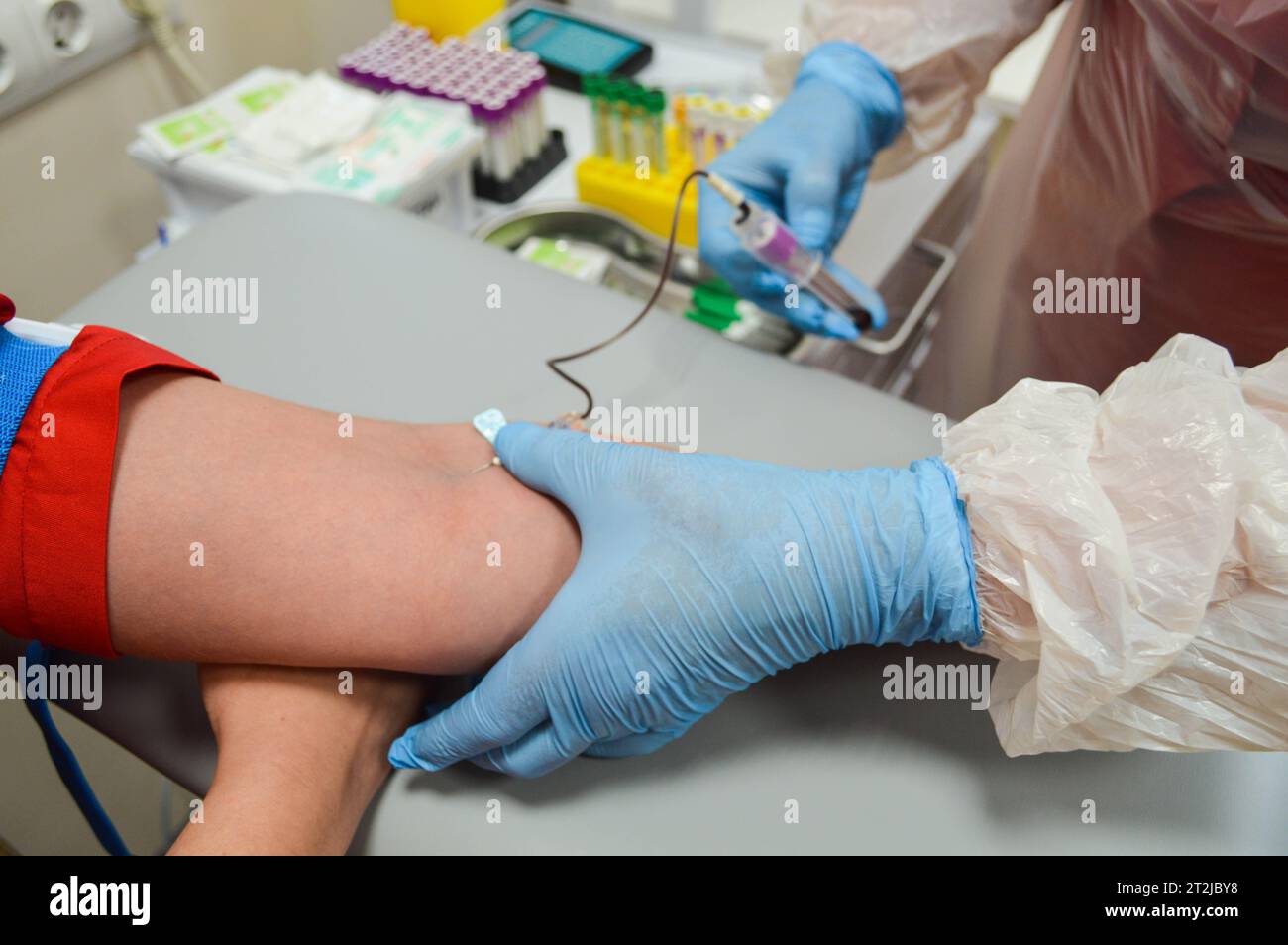 taking blood from a vein. clamping the vein with a disposable medical