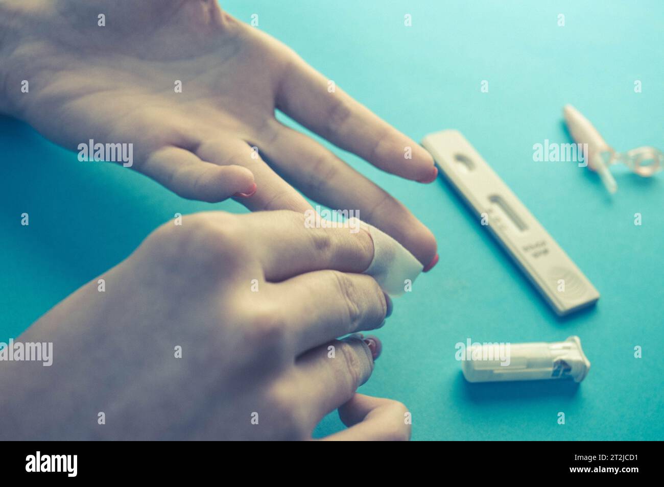 blood test in the laboratory. fingerstick testing and sampling. capillary blood, preparing a finger for a puncture. rubbing the finger with an alcohol Stock Photo