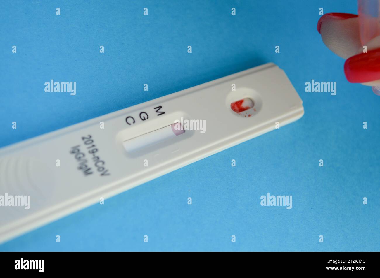 Sensitive Test Lab Signs test strip for the determination of coronavirus on a blue background. a ...