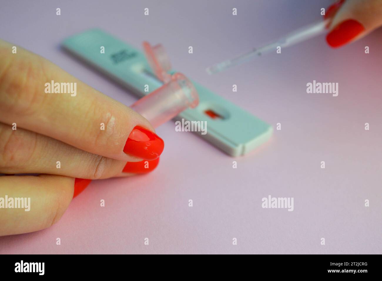 A Girl with a Bright Red Manicure Holds a Coronavirus Test and a Lancet for  a Blood Test in Her Hand. Determination of IgG and IgM Stock Photo - Image  of girl