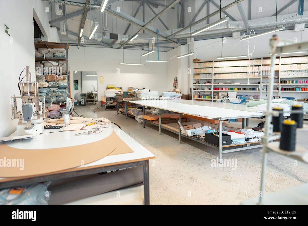 Interior of a sewing warehouse of furniture factory with equipment and ...