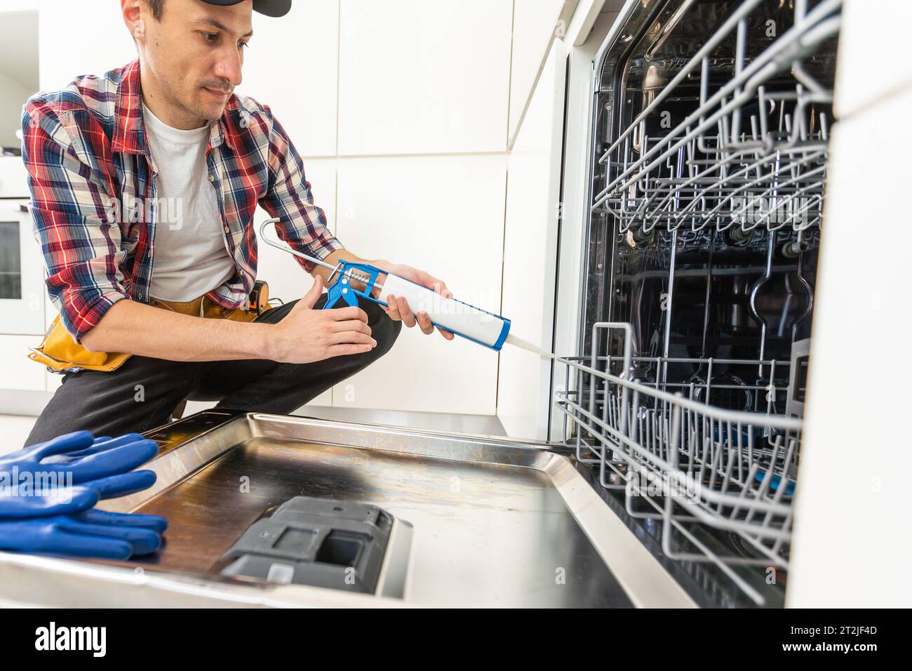 Process of dishwashing machine installation. Young African service man