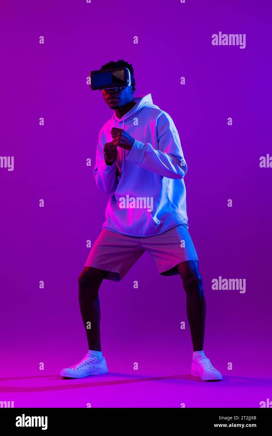Young African man wearing VR glasses and interacting with virtual ...