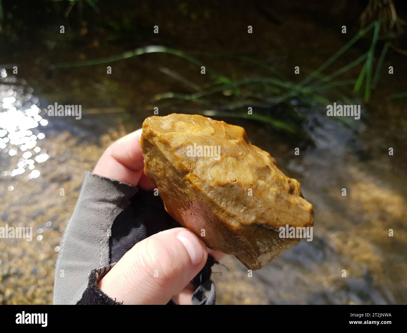 Flint hand axe found in the river, Neolithic era. Ancient stone tool of the Stone Age. Kaluga region, Russia Stock Photo