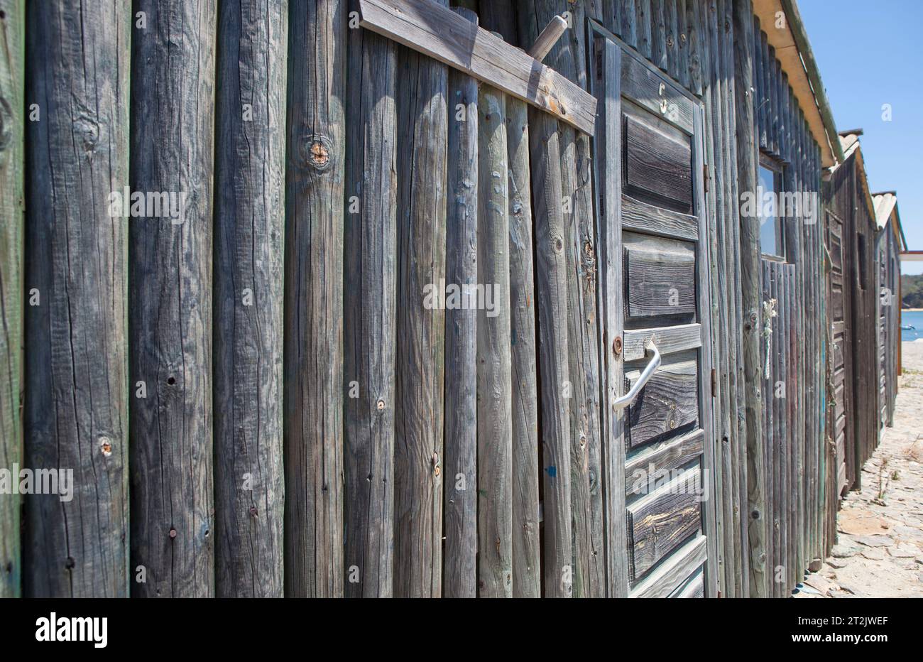 Weathered wooden walls built with logs. Dark knotted and faded greyish look Stock Photo