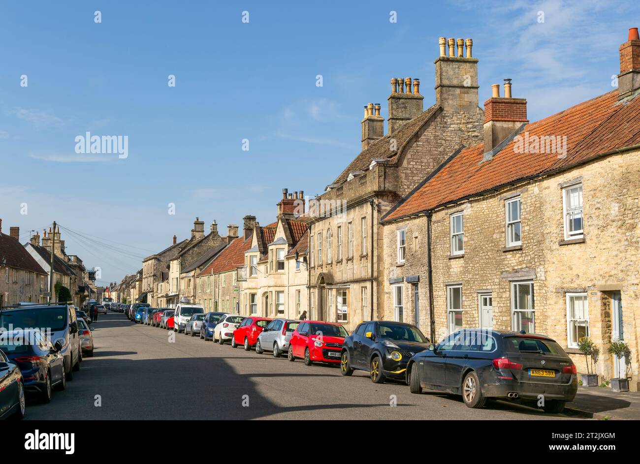 Cars parked on street of historic buildings, Marshfield, Gloucestershire, England, UK Stock Photo