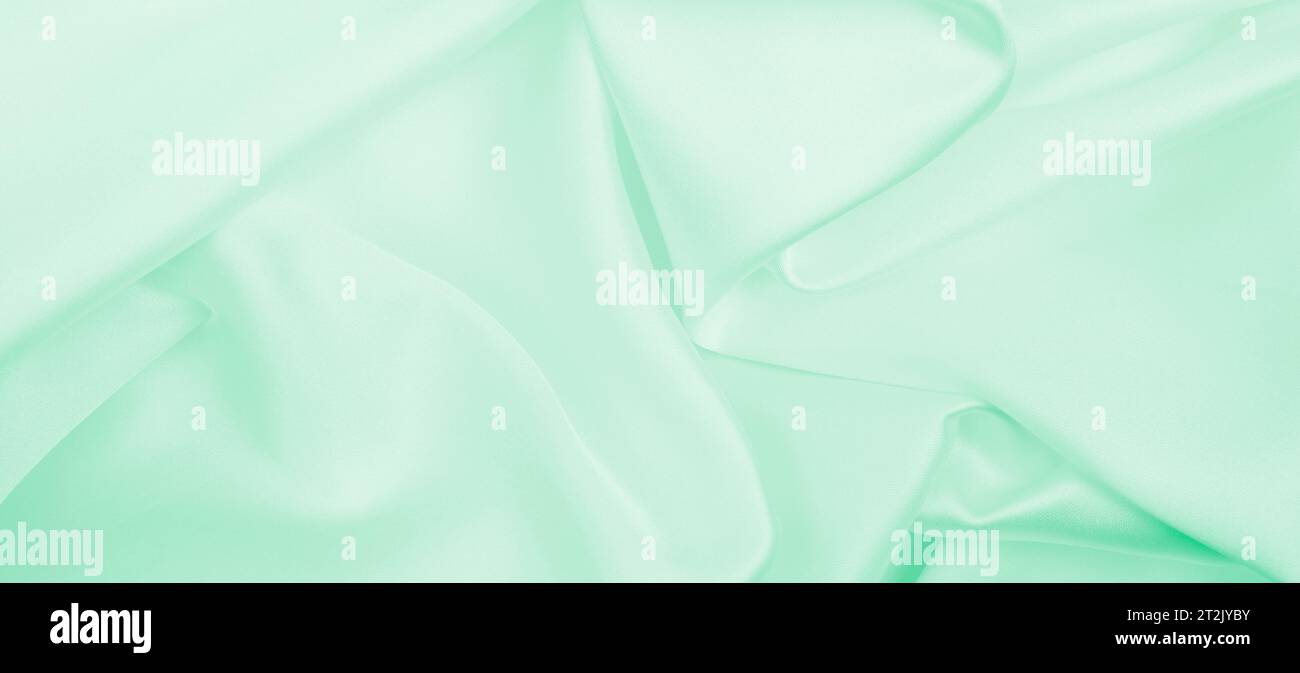 Smooth elegant green silk or satin luxury cloth texture can use as ...