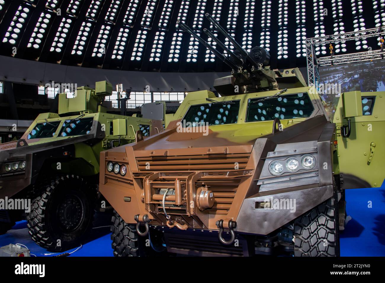 Armored combat vehicle painted in camouflage colors, armed with lethal machine gun and rocket launcher, at the international arms fair in Belgrade Stock Photo
