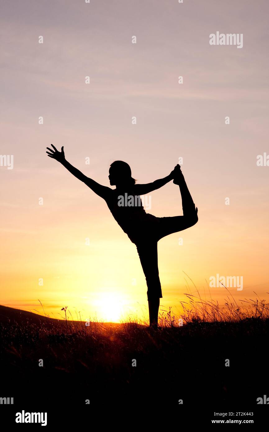 A fit woman practicing yoga in the Columbia Gorge, Oregon. Stock Photo