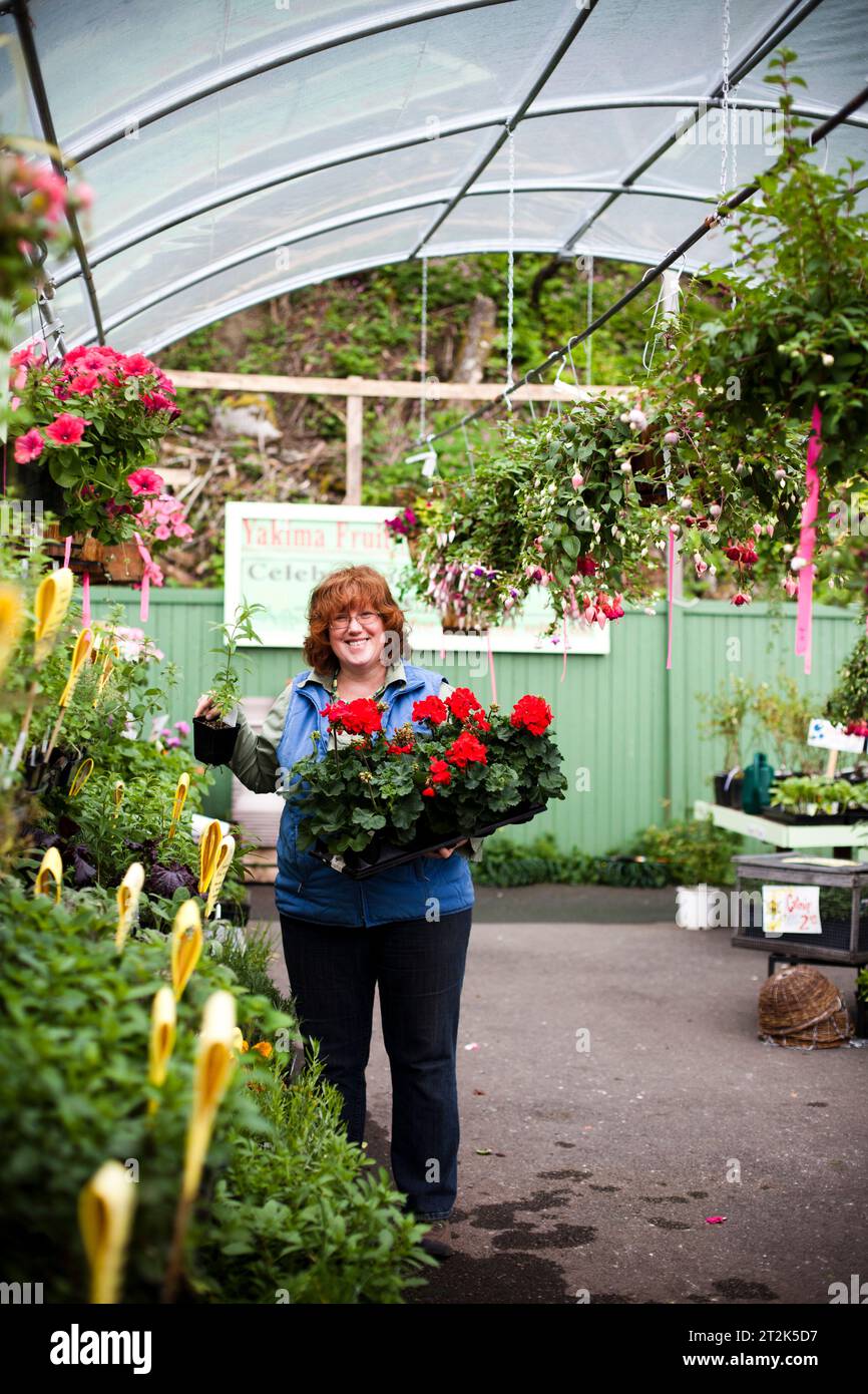 Female gardener in a greenhouse Stock Photo - Alamy