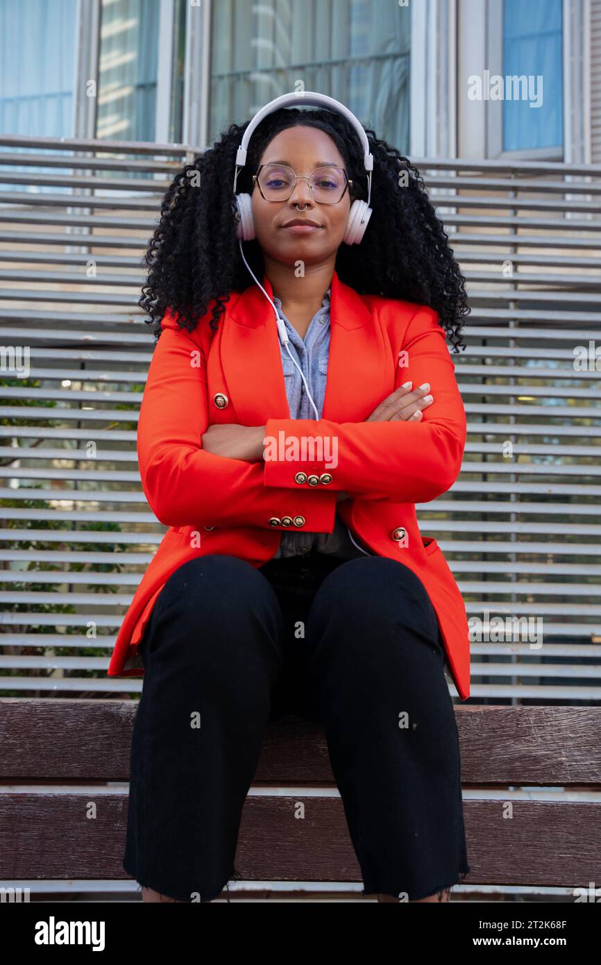 Vertical portrait of an African American businesswoman sitting outdoors Stock Photo