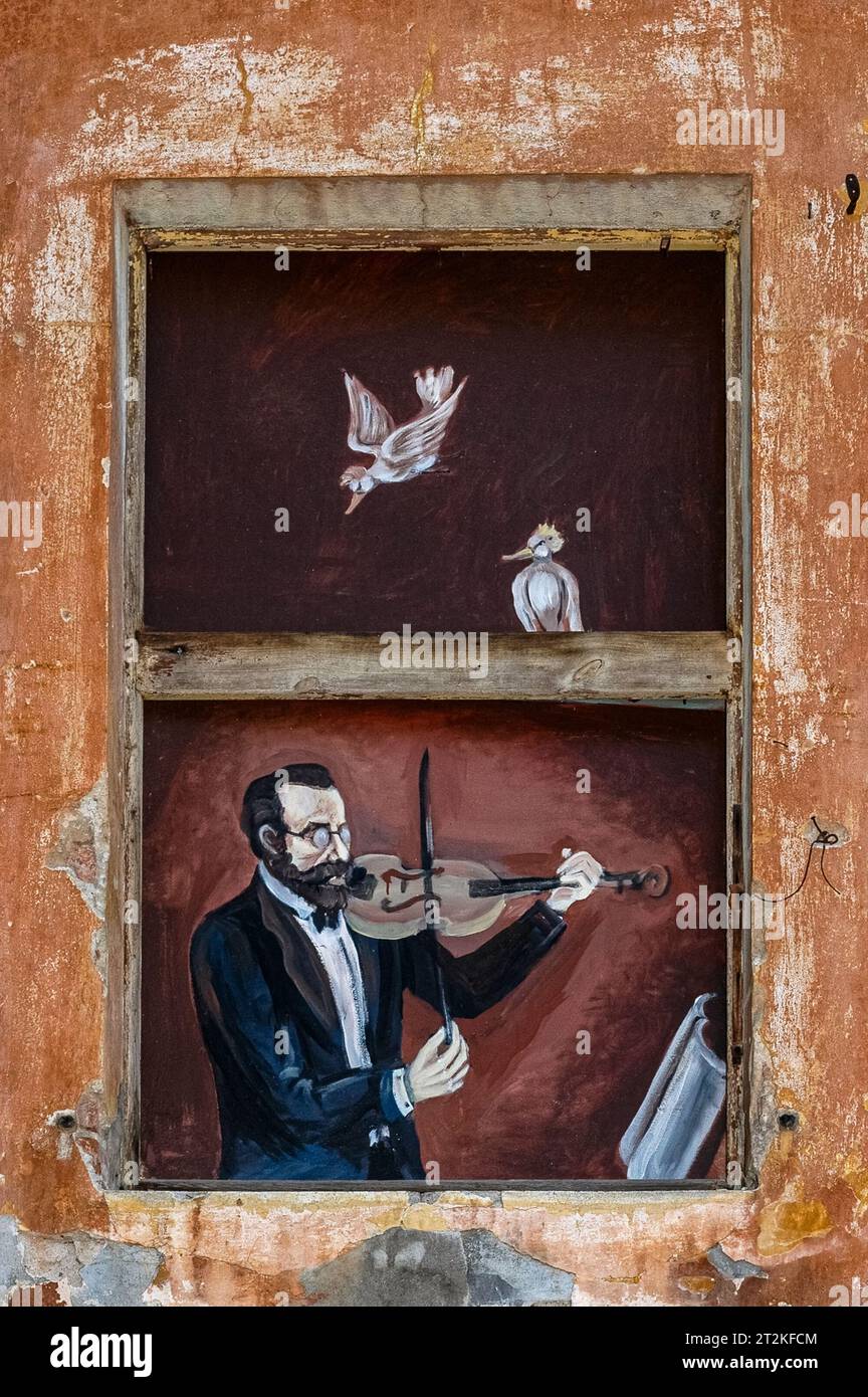 Man in jacket and bow tie playing a violin.  Street art on exterior of building in historic centre of Písek, South Bohemia, Czechia. Stock Photo