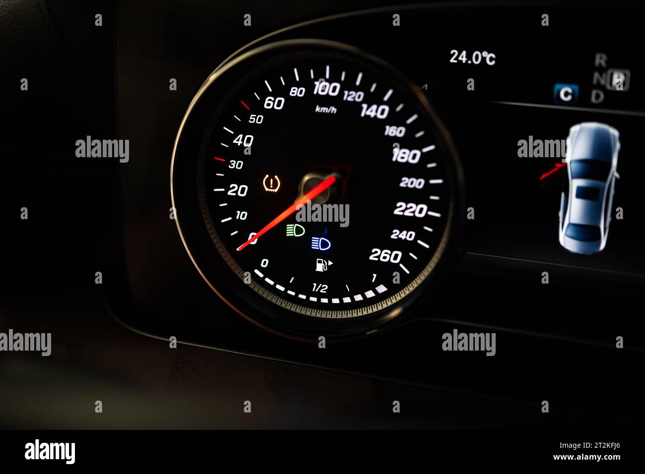 Modern car lit speedometer on the dashboard. Close up shot, km/h
