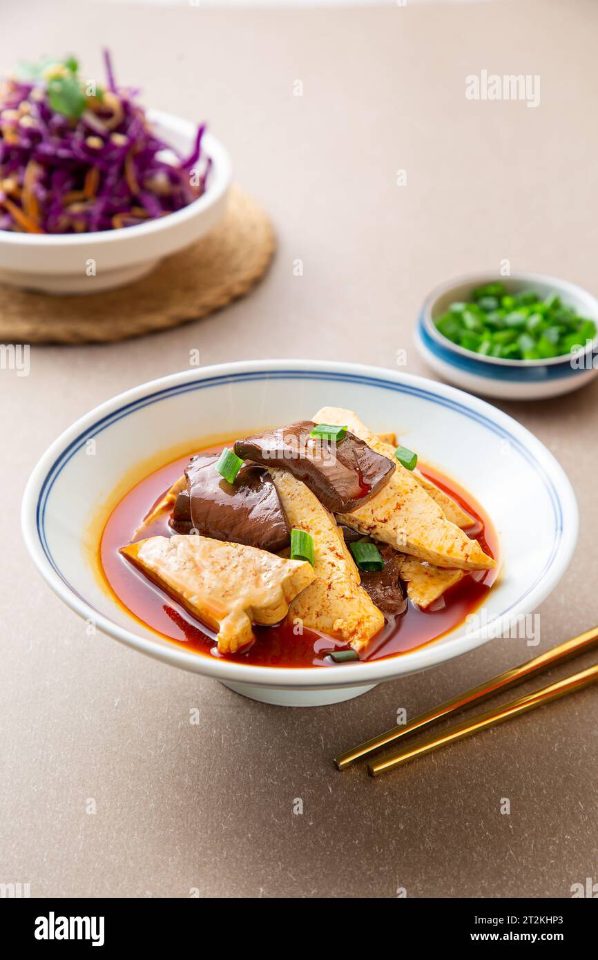 Delicious spicy duck blood jelly soup bowl and stinky tofu with scallion and chili peppe Stock Photo