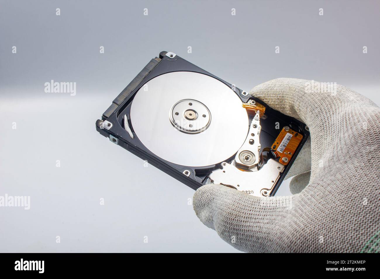 Hard drive, open, interior with trays and head, on gray background