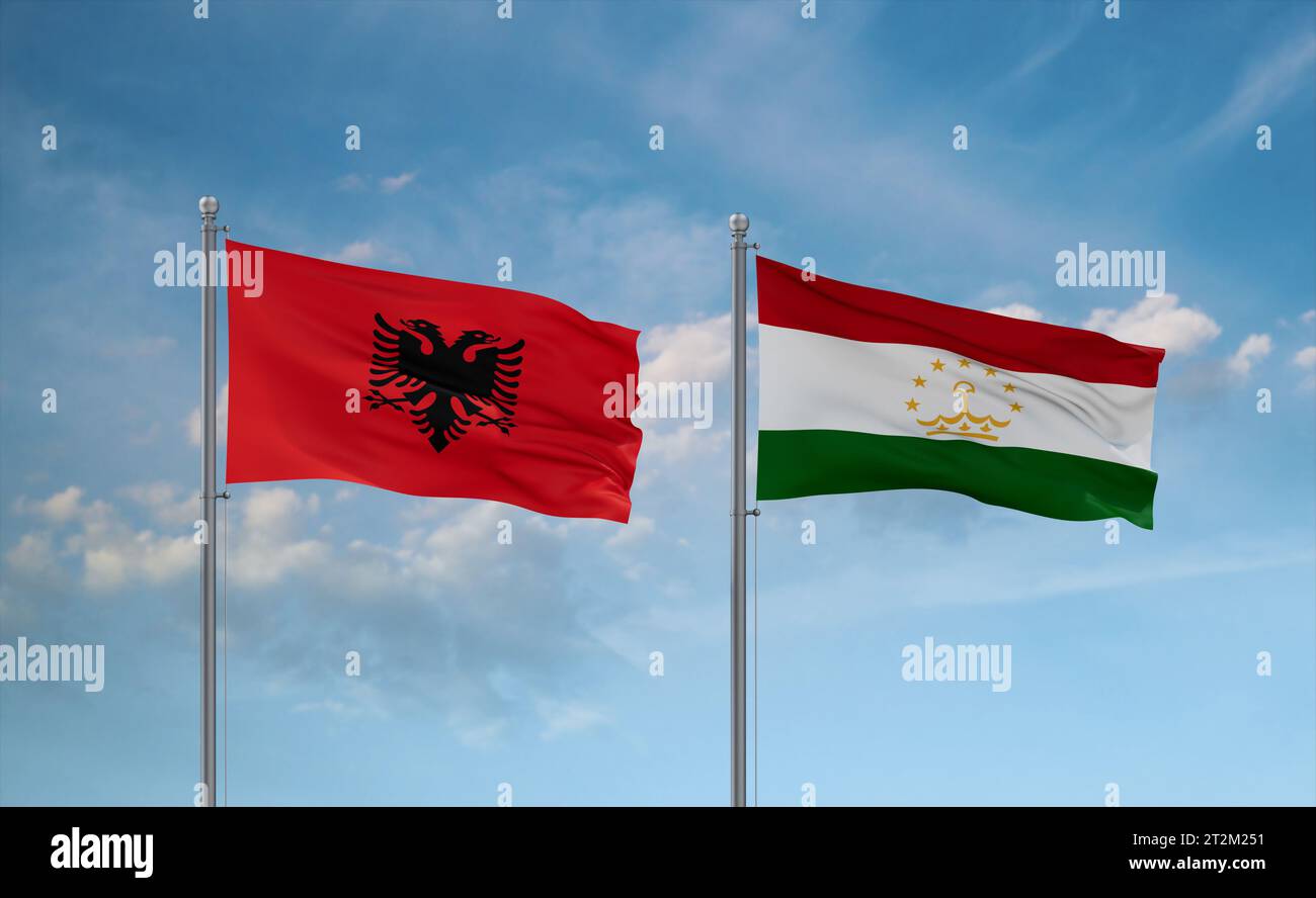 Tajikistan and Albania flags waving together in the wind on blue cloudy ...