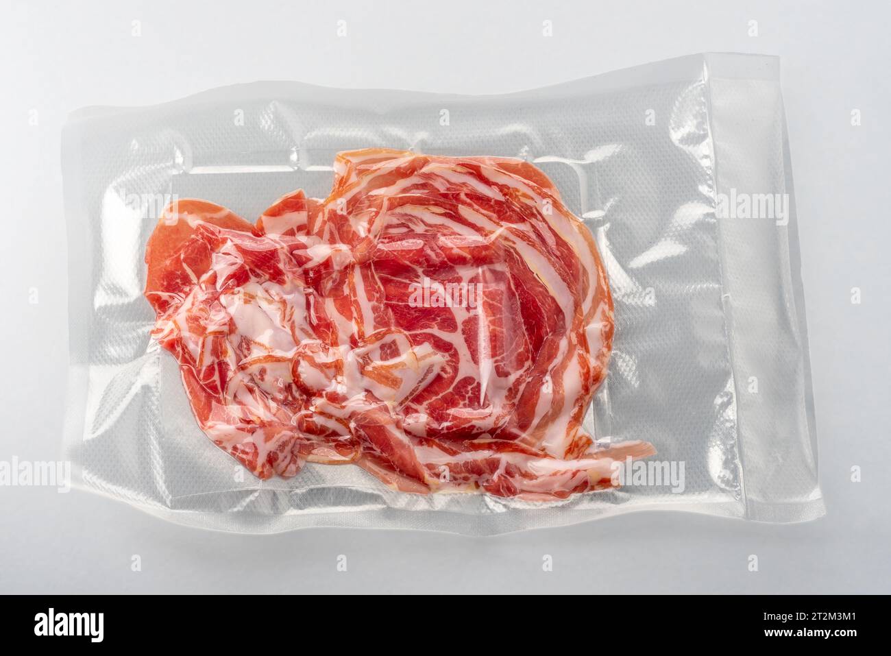 Thin slices of bacon in vacuum pack for sous vide cooking isolated with