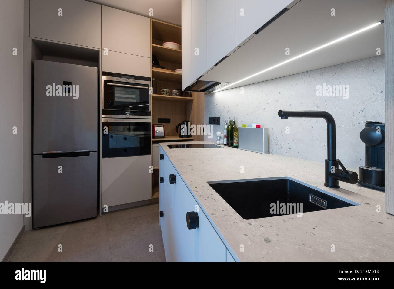 Kitchen with built in appliances of small urban apartment Stock Photo ...