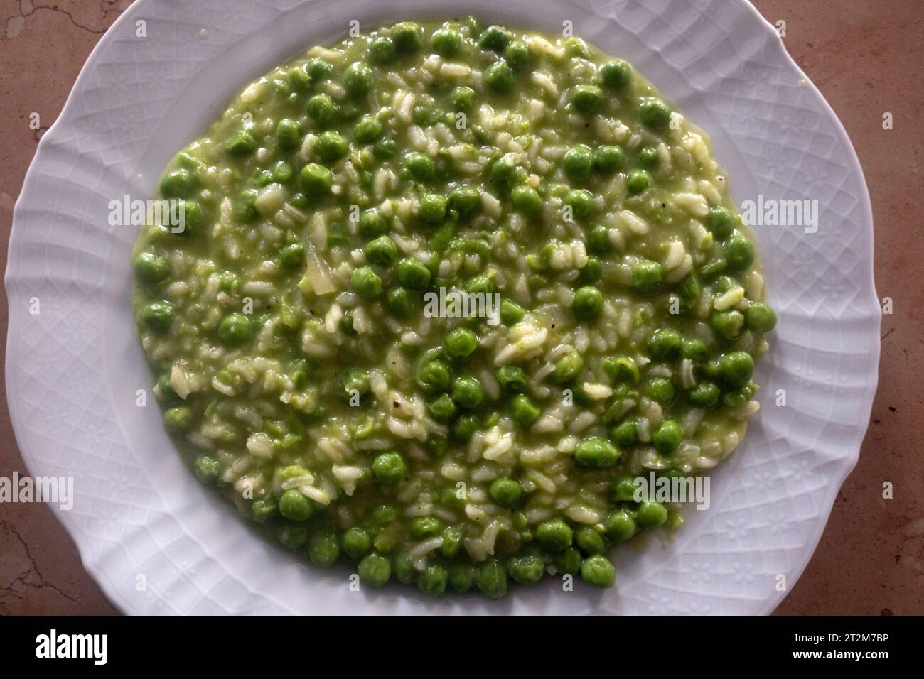 Typical dish of traditional Venetian cuisine rice and peas 'risi e bisi' in Venetian dialect Stock Photo