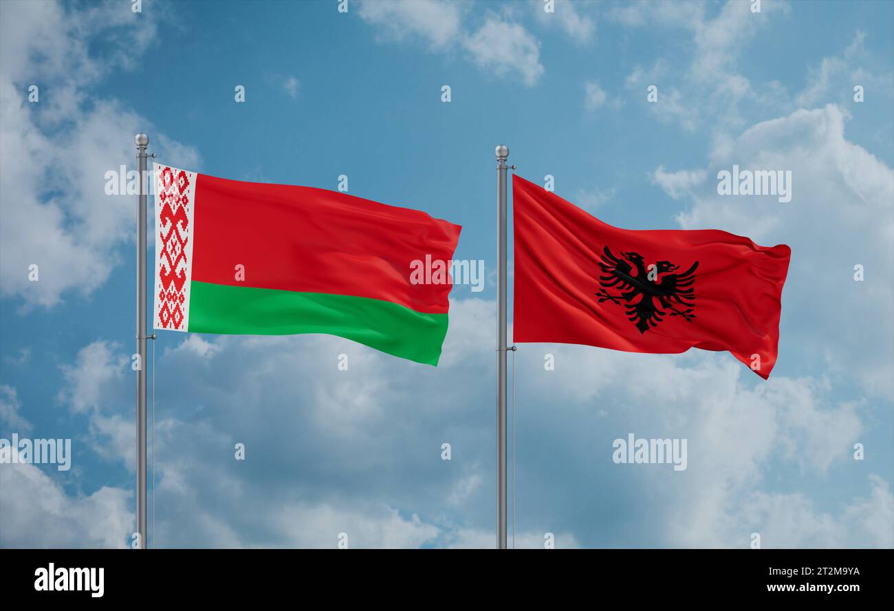 Belarus and Albania flags waving together in the wind on blue cloudy ...
