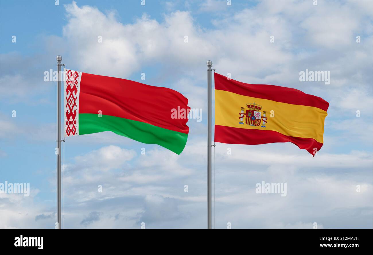 Spain and Belarus flags waving together in the wind on blue cloudy sky ...