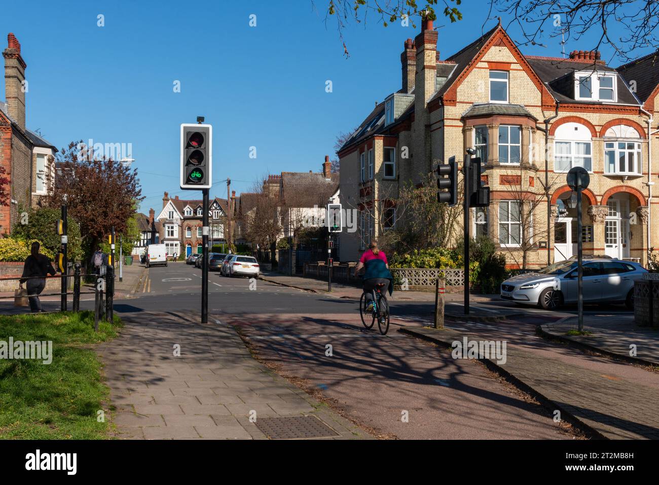 A cyclist, obeying the law, going through a bike path junction when the
