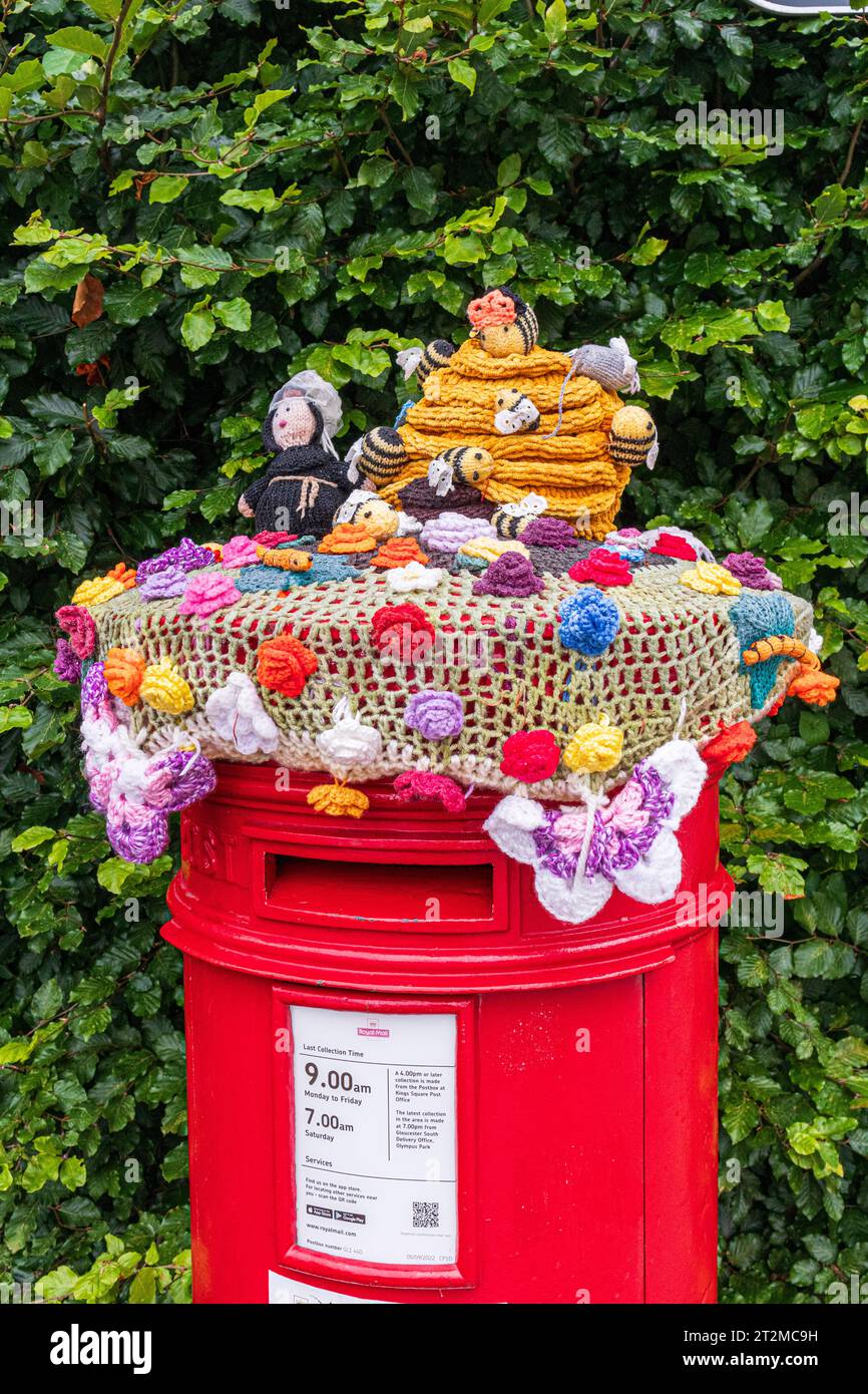 Knitted and crocheted decoration for a Royal Mail post box near Gloucester Cathedral, England UK Stock Photo
